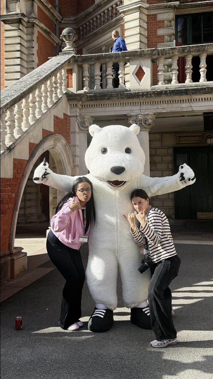 Anastasiia and a colleague with the university mascot